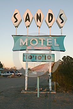 Neon lights come on at sunset at Sands Motel with RV Parking for $10, located at the intersection of Route 54 & 380 in Carrizozo,