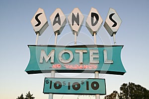 Neon lights come on at sunset at Sands Motel with RV Parking for $10, located at the intersection of Route 54 & 380 in Carrizozo,