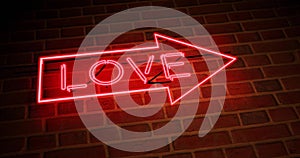 Neon love sign above entrance is advertising for nightclub or massage - 4k