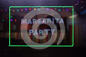 Neon Margarita Party Sign in Rainy Window