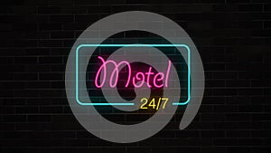 Neon Motel 24/7 sign glows and lights on grunge brick wall.