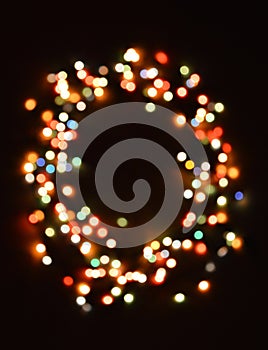 Neon multicolored festive wreath. preparation for Christmas and New Year. bokeh on a black background.
