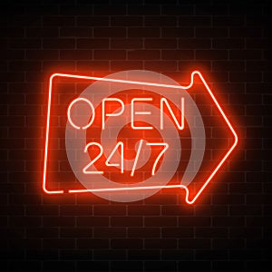 Neon open 24 hours 7 days a week sign in geometric arrow shape on a dark brick wall background.