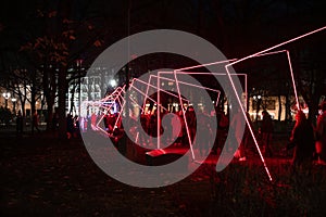 Neon red geometric light arches in a park at Staro Riga 2025, Latvia