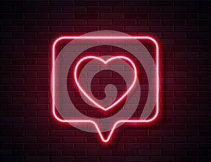 Neon Red Glowing Heart in Spech Bubble Banner on Dark Empty Grunge Brick Background.