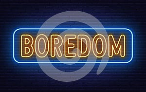 Neon sign Boredom on brick wall background.