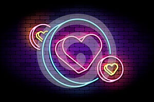 Neon sign with hearts in circles.