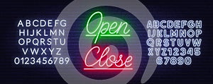 Neon sign open and close on brick wall background.