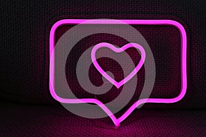 Neon sign pink like Instagram heart in the decor. Trendy style. Valentine day