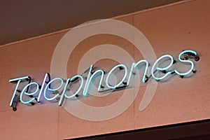 Neon sign reading Telephones