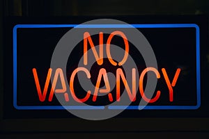 Neon sign reads ï¿½No Vacancyï¿½ for a motel at night