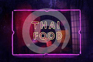 Neon Sign Thai Food in Wet Rainy Window