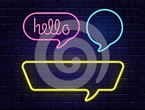 Neon speech bubbles set with space for text. Hello neon lettering. Realistic color neon banners isolated on brick wall