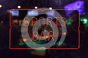 Neon Sports Bar Sign, Rainy Window Blur Image