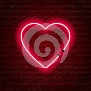 Neon tubes in the shape of a heart isolated on a brick wall background. Sign of love.