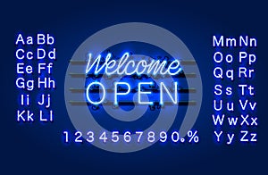 Neon welcome open signboard on the brick wall background