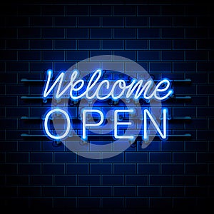 Neon welcome open signboard on the brick wall background.