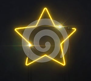 Neon yelllow star shaped line on dark background