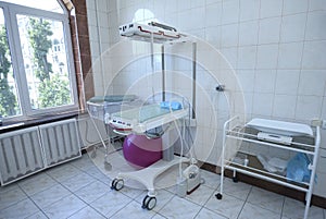 Neonatal incubator and weights for newborn baby, part of medical equipment of delivery room