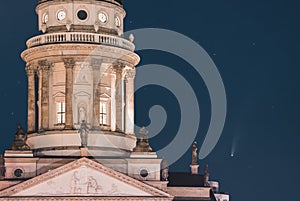 Neowise Comet visible in city of Berlin over Berlin Cathedral with illuminated night sky. Astro photo during night time