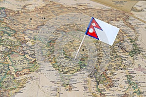 Nepal flag pin on a world map photo