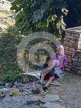 NEPAL, November, 2018: Annapurna Base Camp hiking trek, Himalayas, Nepal. November, 2018. Local children observe tourists