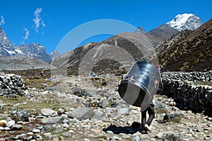 Nepal Porter carrying heavy load on his back.