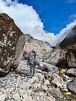 Nepal Porter carrying heavy load on his back.