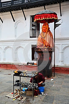 Nepalese people pray with Hanuman statue at Basantapur Durbar Square