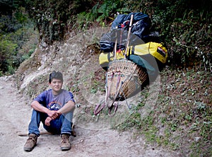 Nepalese porter along the road to the top