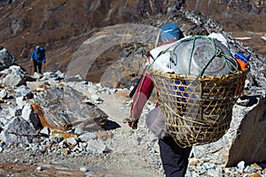 Nepalese Porter carrying Basket with rural household goods