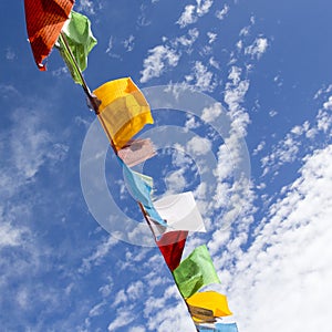 Nepalese prayer flags against the blue sky.