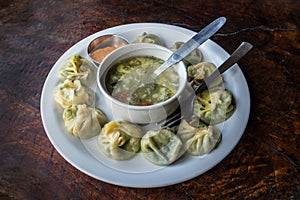 Nepalese traditional dumpling momos served with tomato chatni