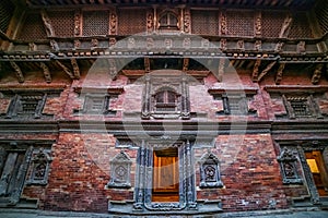 Nepalese traditional style windows, doors and wood carvings on the walls of an ancient palace.