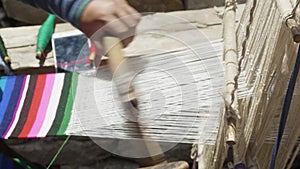 Nepalese woman weaves woolen scarf.