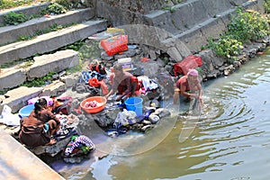 Nepalese women washing clothes along the river