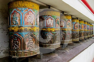 Nepali buddhist prayer wheels with letter symbols