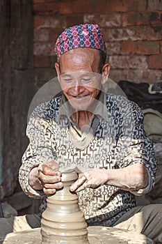 Nepali man enjoying his pottery work