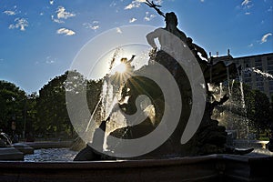 Neptune Fountain Berlin Alexanderplatz with background sun