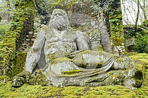 Neptune sculpture, a statue in famous park of the monsters in Bomarzo Italy
