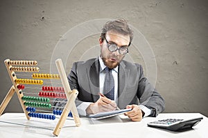 Nerd accountant does calculation of company revenue