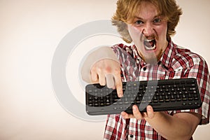 Gamer man holding computer keyboard