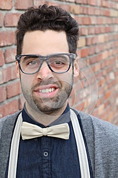 Nerd Guy With Glasses, Bow Tie, and Brick Wall Background