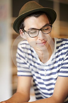 Nerd, man and thinking with a smile in home with ideas of future, growth and daydream with hope. Hipster, person and