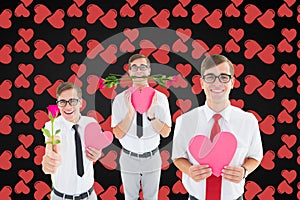 Nerd men holding red roses and pink heart against digitally generated background