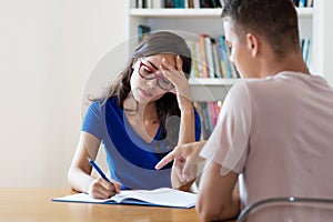 Nerdy female student with eyeglasses learning with concentration