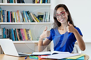 Nerdy female student learning language online using computer