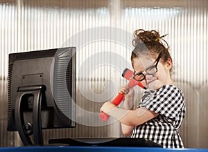 Nerdy girl smashing her computer