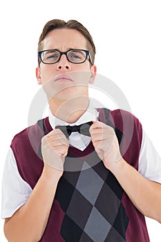 Nerdy hipster fixing his bow tie