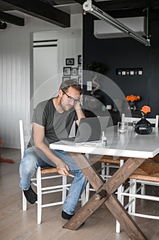 Nerdy man with glasses freelance working from home during the covid pandemic or flu